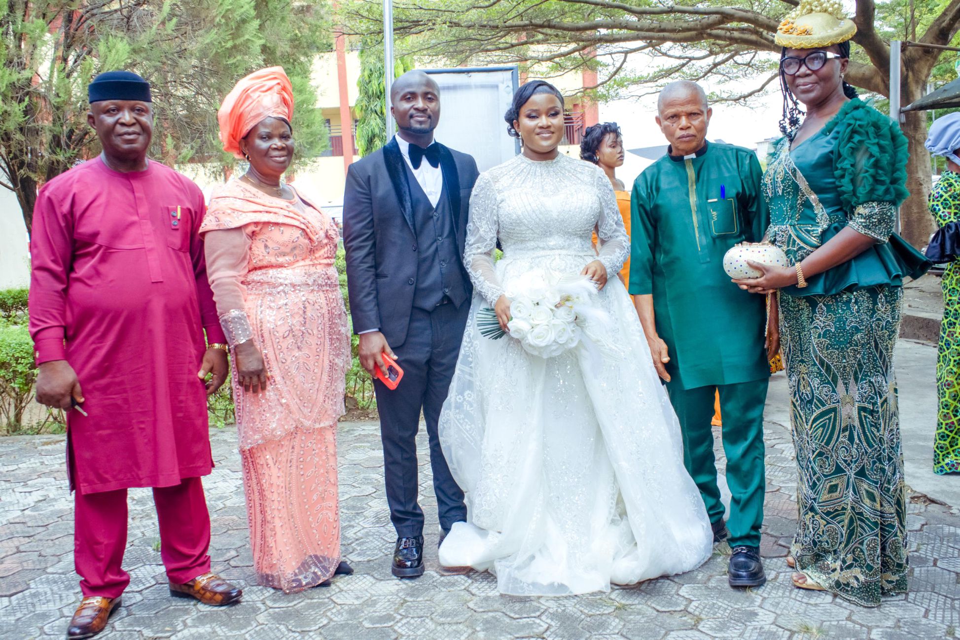 Couple with their parents. Right: Brides parents: Ven. Ngozi and Faith Ofoegbulam . Left: Pastor Chima and Elder Francisca Mbisike.